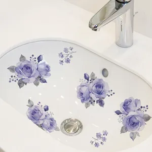 Detailed view of purple rose floral decals applied to a white ceramic bathroom sink