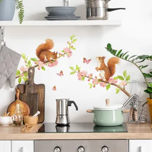 Watercolor squirrel and cherry blossom wall sticker applied in a modern kitchen scene.