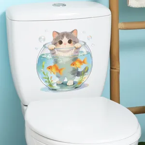 Detail of cute cartoon cat in fishbowl sticker applied to white bathroom toilet tank.