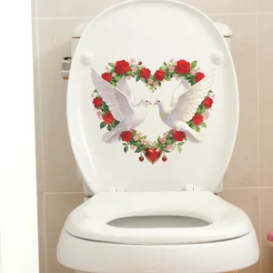 Close-up of heart rose wreath and peace dove sticker applied on a white toilet lid surface