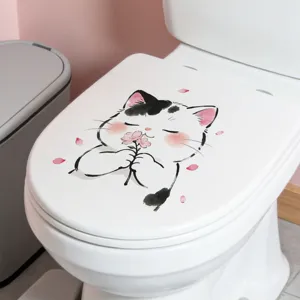 Detail view of a cute cartoon cat holding a flower sticker on a white toilet lid