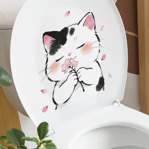 Close-up of cute cartoon cat sticker with pink flowers on white toilet seat lid
