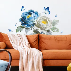 Detailed view of 3D relief peony wall stickers in blue and white over an orange sofa