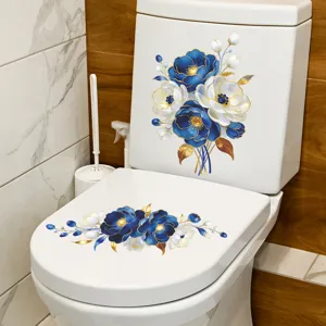 Blue and white floral toilet sticker with gold accents on a white toilet lid and tank