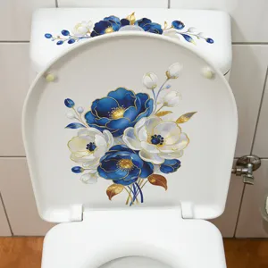 Close-up detail showing blue and white floral stickers on a white porcelain toilet