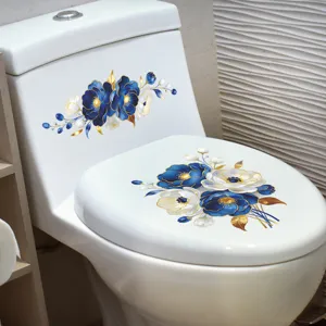 Detail view of blue floral toilet stickers applied to a white ceramic toilet lid