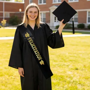 Detailed view of a black graduation sash with gold French lettering worn by a model