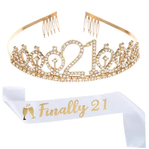 Detail view of golden 21st birthday tiara and white satin Finally 21 sash set
