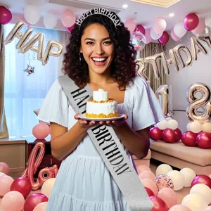 Woman wearing silver glitter Happy Birthday sash and headband in party room