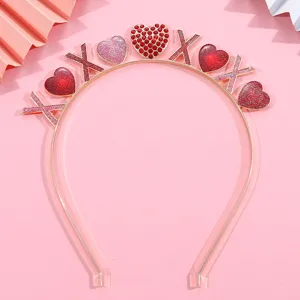 Close-up detail of a pink Valentine's headband with glitter hearts and XOXO accents