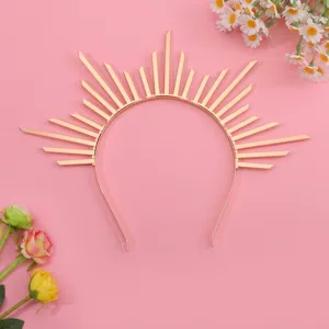 Golden sunburst goddess halo headband crown hair accessory on pink background