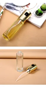 Close-up detail of the clear glass bottle body and golden spray nozzle pump head component.