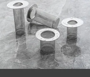 Stainless steel floor drain filter mesh detail, close-up of fine wire mesh on wet marble.