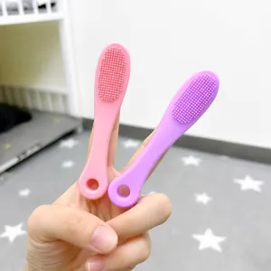 Portable silicone massage brush and shower scrubber in pink and purple colors with hang hole.
