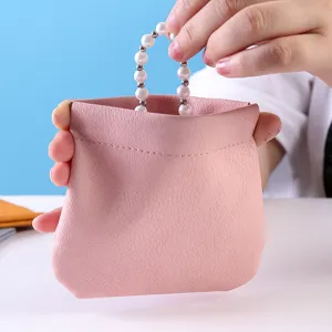 Portable mini pink leather makeup pouch with pearl handle, cute lipstick storage bag.