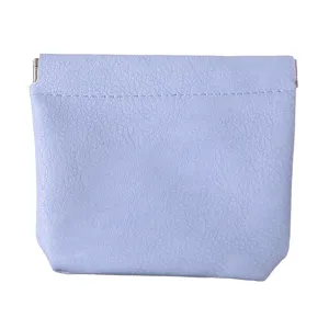 Portable mini leather cosmetic pouch with automatic closure, ideal for lipstick and small items.