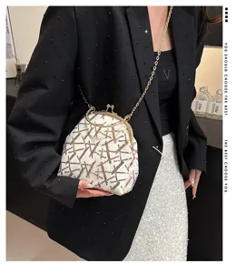 Detail view of stylish white shell crossbody bag with golden sequins and chain strap