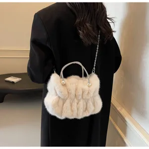 Elegant white fluffy faux fur bag with crystal handle and pearl accents shown on model