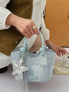 Light blue denim pattern bucket handbag featuring a silver starfish charm and knot handle