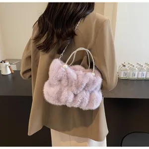 Detail of a purple fluffy faux fur handbag with sparkling rhinestone handles and pearl accents