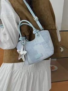 Stylish denim blue bucket handbag for women with silver star charm and crossbody strap.