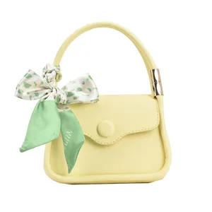 Elegante mini gelbe Handtasche mit Griff und grünem floralem Seidenschal Dekoration