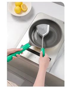 Silicone anti-scald handle cover detail shot, kitchen cookware accessory in use on pan.