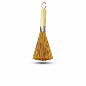 Traditional bamboo pot brush with long wooden handle and hanging loop for kitchen cleaning.