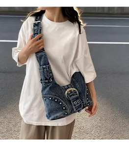 Street style view of vintage denim underarm bag with punk rivets and large buckle