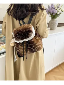 Cozy fuzzy brown spotted backpack with delicate white lace trim on model's back