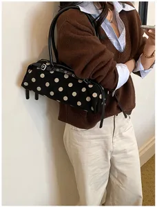 Retro black polka dot Boston bag in suede material styled on an Asian model's shoulder