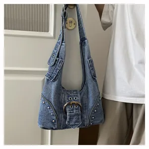 Detail of vintage denim shoulder bag with punk rivets and large belt buckle decoration