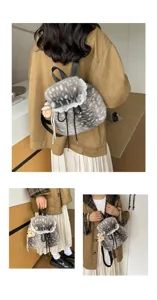 Faux fur deer print backpack with lace trim and bear charm in lifestyle setting