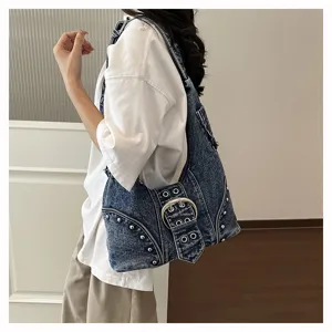 Vintage distressed denim underarm bag with punk studs and large silver belt buckle