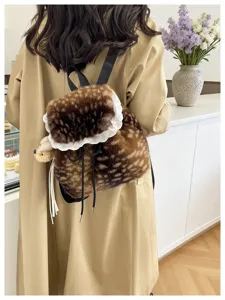 Back view of a faux fur deer print backpack with white lace trim and plush bear charm