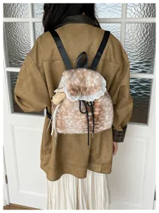 Detailed back view of a fluffy fawn-patterned backpack with white lace trim on a model