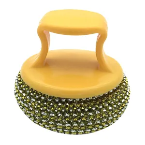 Ergonomic kitchen cleaning brush with yellow handle and sparkly dish scrubber for pots.
