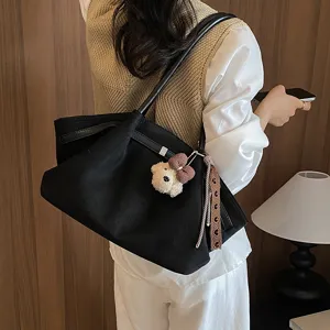 Retro black suede tote bag with cute plush bear charm for large capacity daily commute