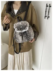 Detailed close-up of the soft faux fur texture and elegant lace trim on this backpack