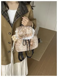 Detailed view of autumn plush deer print backpack with lace trim and bear charm