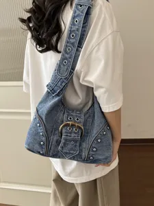 Retro distressed blue denim shoulder bag featuring punk rivets and large metal buckle