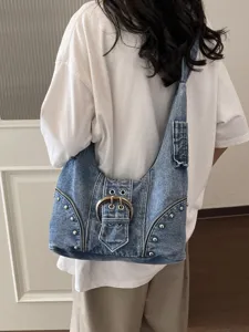 Vintage distressed denim underarm shoulder bag with punk rivets and large metal buckle