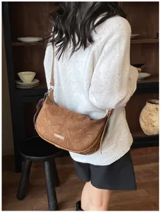 Vintage braune Tasche aus Wildlederimitat in Knödelform an einem Model Rückenansicht.