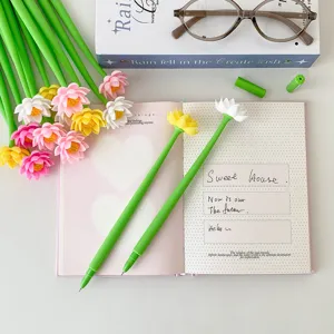 Close-up of cute silicone gel pens with colorful lotus flower designs on a notebook