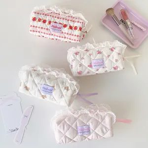 Group view of four aesthetic quilted lace pencil cases with floral and bear patterns
