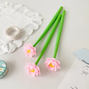 Detailed view of three lotus flower gel pens on a desk with decorative props