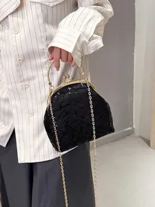 Elegant women's black sequin shell bag featuring a gold chain and clasp closure