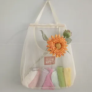 Hanging mesh storage bag detail showing durable white netting and decorative sunflower.