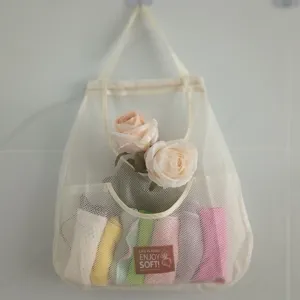 Large wall-mounted mesh storage bag with floral decor, hanging organizer pocket for home use.
