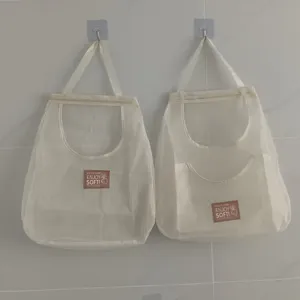 Hanging mesh storage bag for kitchen fruit and vegetable organization wall mounted pocket organizer